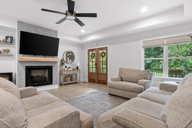 living room with plenty of natural light, wood finished floors, recessed lighting, and ceiling fan