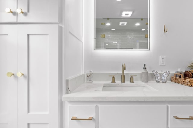 bathroom featuring vanity and a shower with shower door