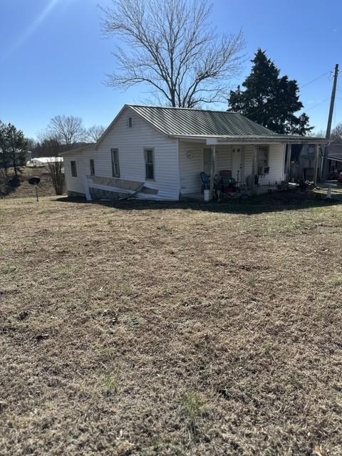 view of side of property with a lawn