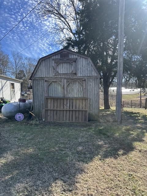 view of outdoor structure featuring a lawn