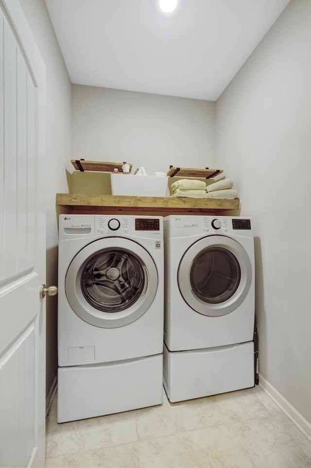 laundry room with washing machine and clothes dryer