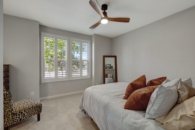 bedroom featuring ceiling fan and light carpet