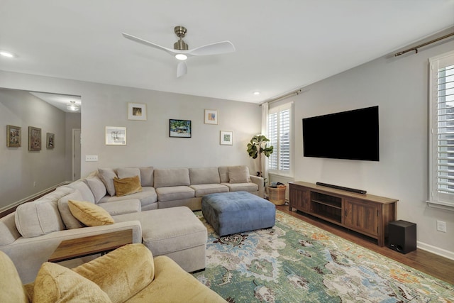 living room featuring ceiling fan and hardwood / wood-style flooring