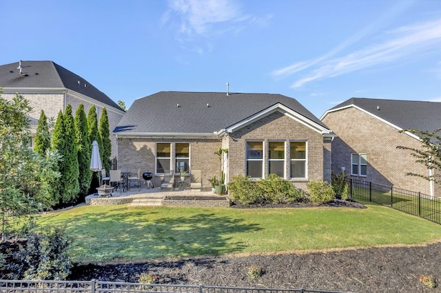 back of property featuring a patio area and a lawn