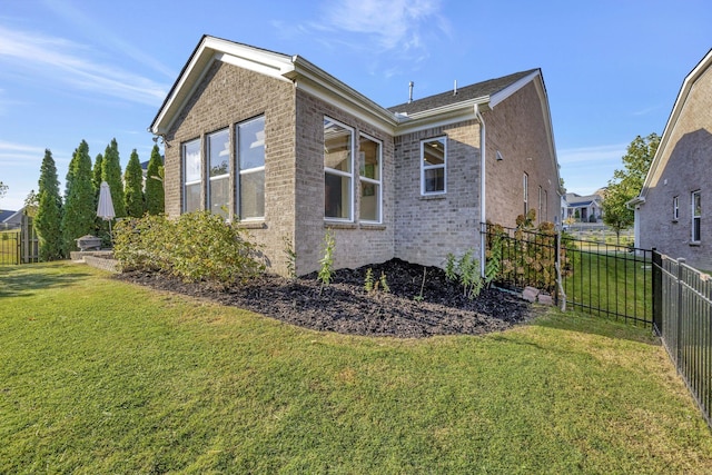 view of home's exterior with a yard