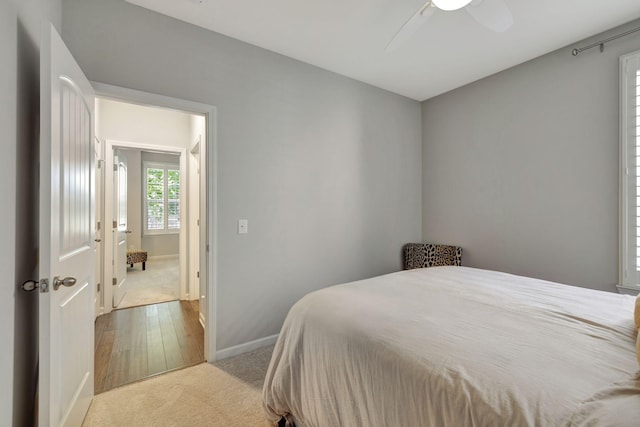 bedroom with ceiling fan and light carpet