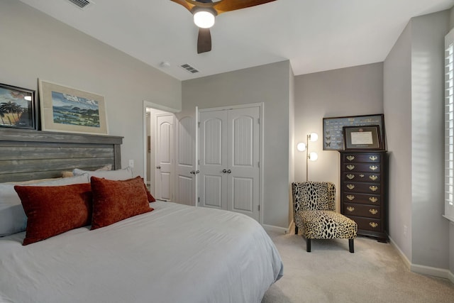 carpeted bedroom with ceiling fan and a closet