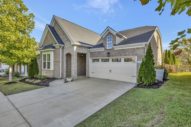 view of front of home featuring a front lawn and a garage