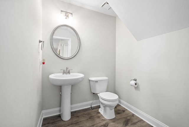 bathroom with wood-type flooring, sink, and toilet