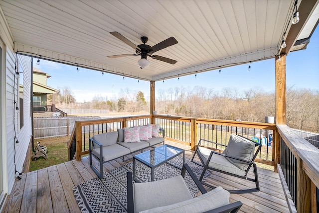 wooden terrace featuring ceiling fan and an outdoor living space