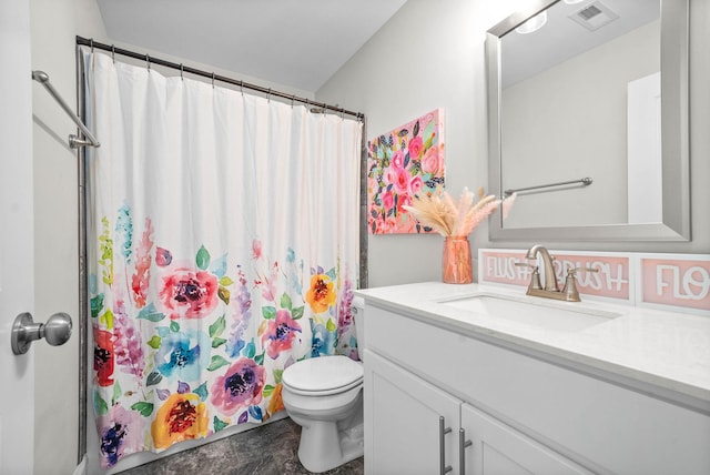 bathroom with toilet, vanity, and a shower with curtain