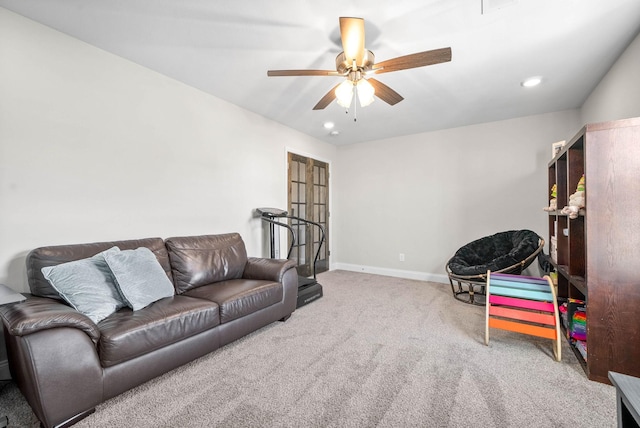 carpeted living room with ceiling fan