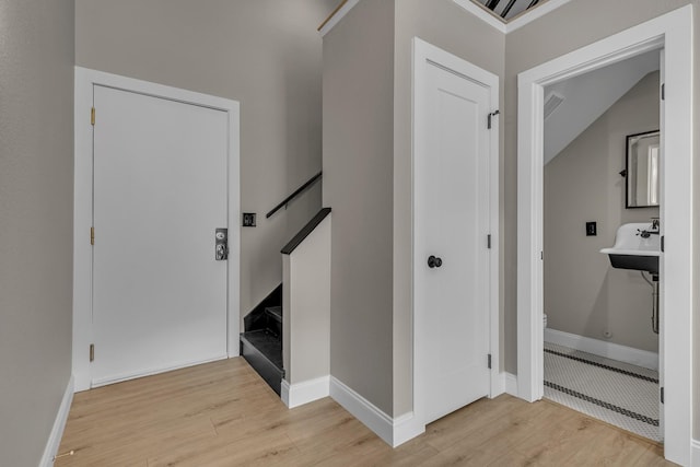 staircase with vaulted ceiling and hardwood / wood-style flooring