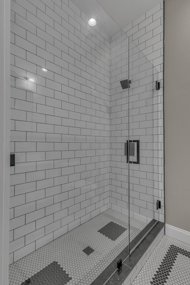 bathroom featuring an enclosed shower and tile patterned flooring