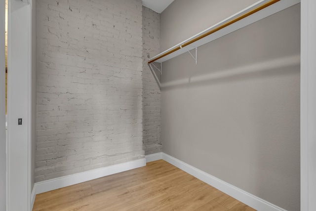 spacious closet with hardwood / wood-style flooring