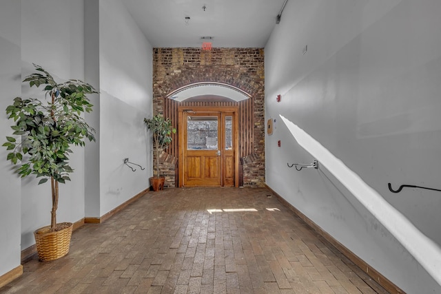 foyer entrance with brick wall