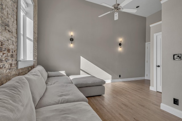 living room with ceiling fan and light wood-type flooring