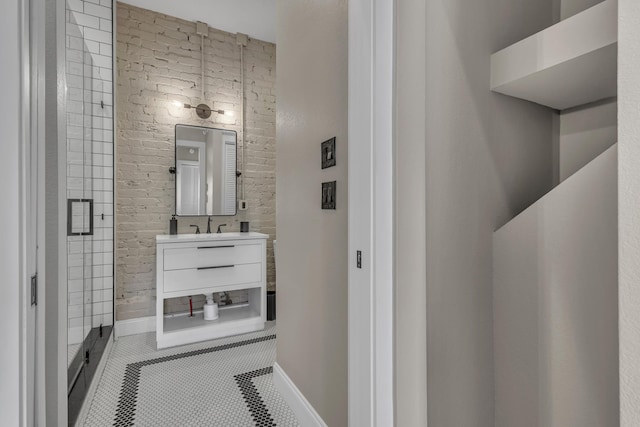 bathroom featuring a shower with door, vanity, and tile patterned flooring