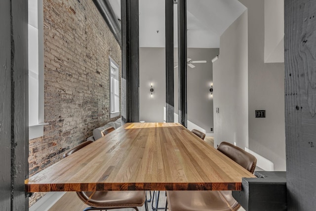 unfurnished dining area with ceiling fan and a high ceiling