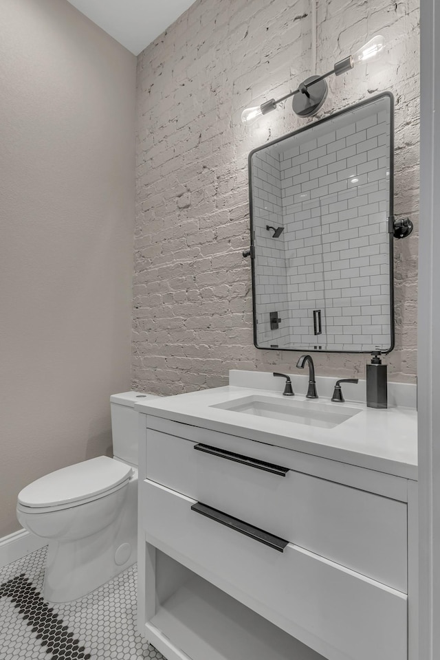 bathroom featuring toilet, vanity, and tile patterned floors