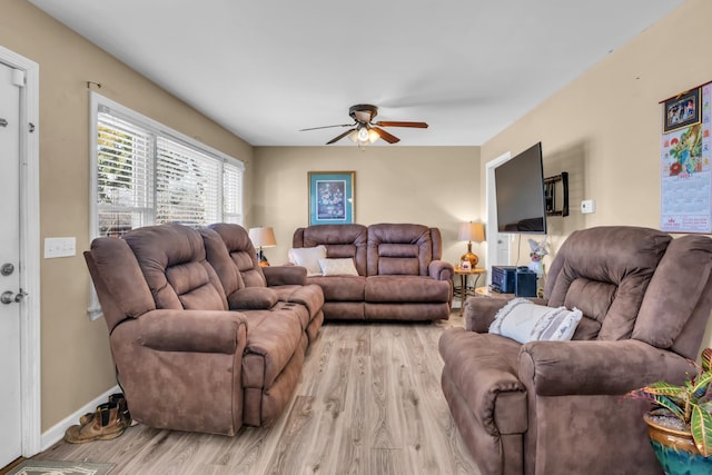 living room with ceiling fan and light hardwood / wood-style flooring