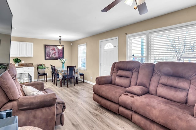 living room with ceiling fan and light hardwood / wood-style floors