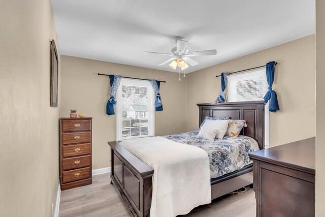 bedroom with ceiling fan and light wood-type flooring