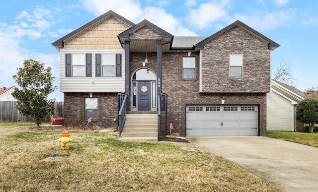 bi-level home featuring a garage and a front lawn