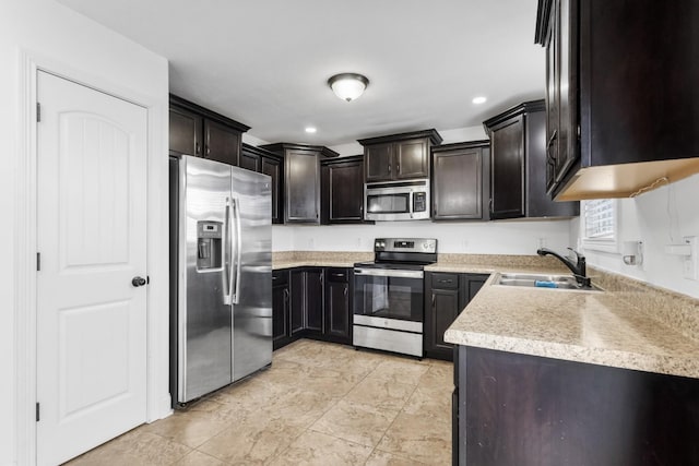 kitchen with dark brown cabinetry, sink, and appliances with stainless steel finishes