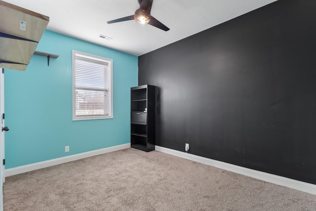 unfurnished room featuring light carpet and ceiling fan