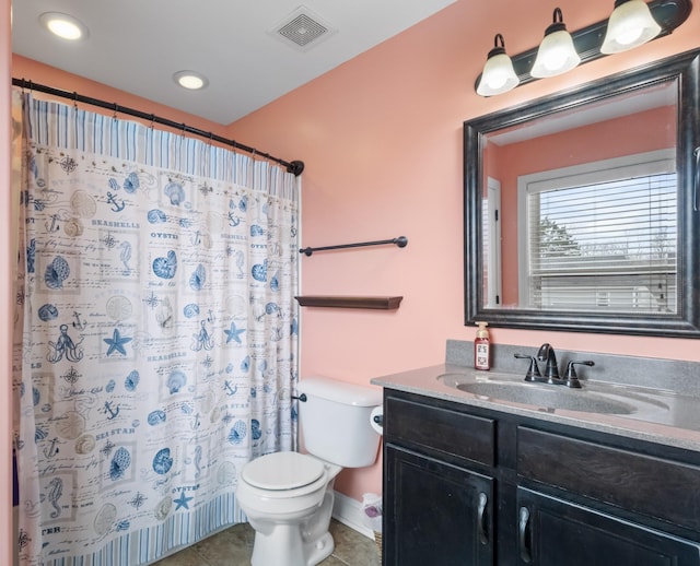 bathroom with vanity, tile patterned floors, toilet, and walk in shower