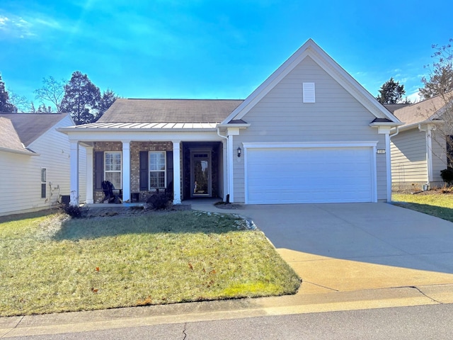 view of front of property with a garage, a front lawn, and a porch