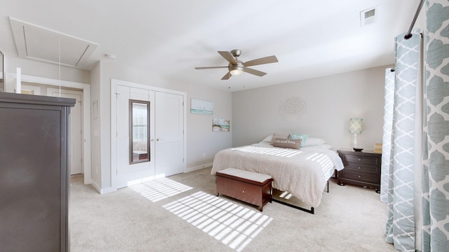 carpeted bedroom featuring ceiling fan and a closet