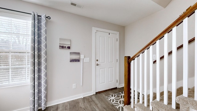 entryway with dark hardwood / wood-style flooring