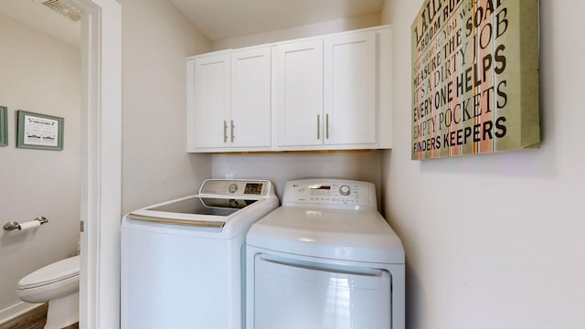 washroom with cabinets and independent washer and dryer