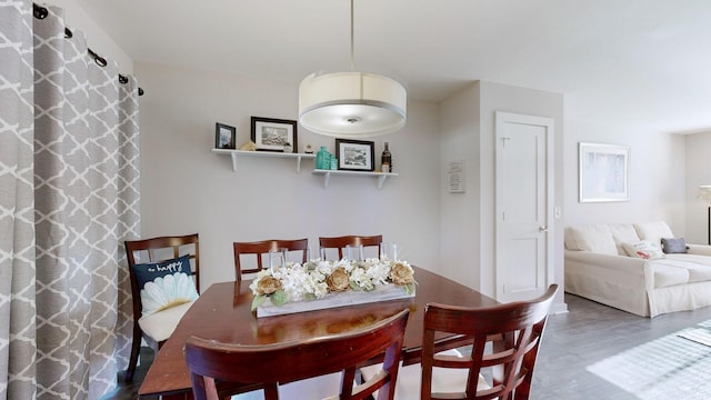 dining space with hardwood / wood-style flooring