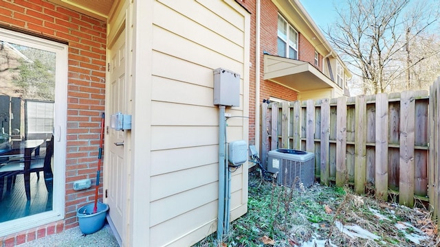 view of side of home with central AC