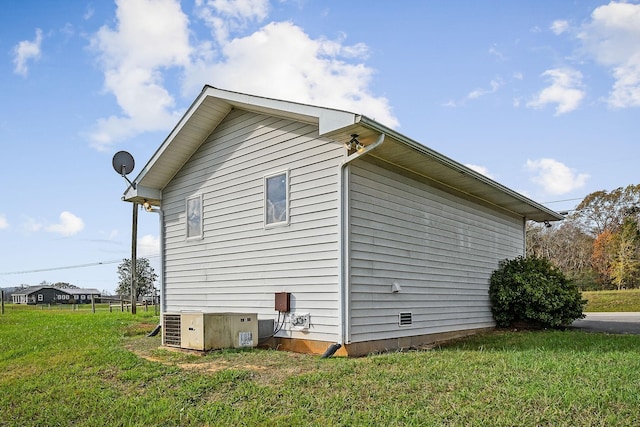 view of property exterior featuring a lawn and cooling unit