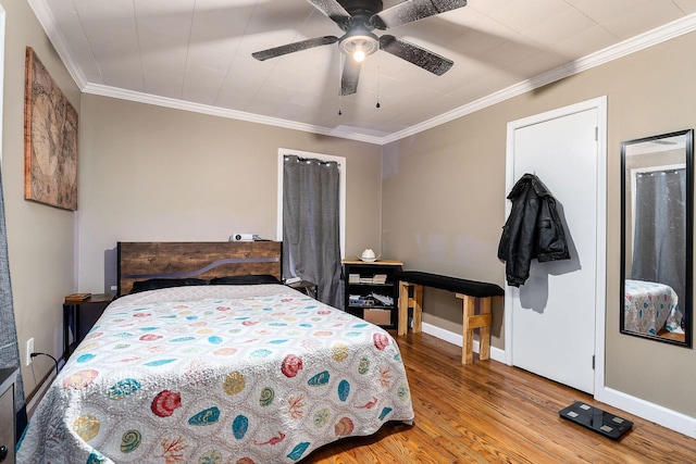 bedroom featuring ceiling fan, hardwood / wood-style floors, and ornamental molding