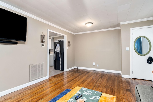 foyer featuring crown molding and dark hardwood / wood-style floors