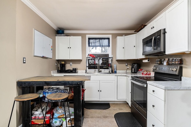 kitchen featuring appliances with stainless steel finishes, ornamental molding, white cabinetry, and sink