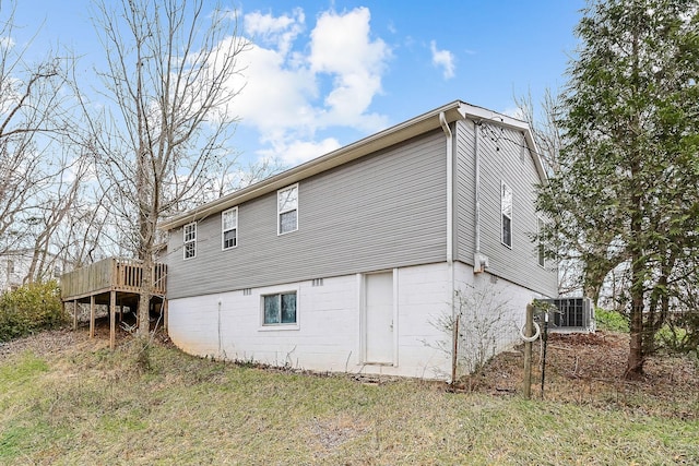 view of side of property featuring cooling unit and a deck