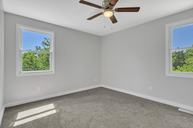 carpeted spare room featuring ceiling fan