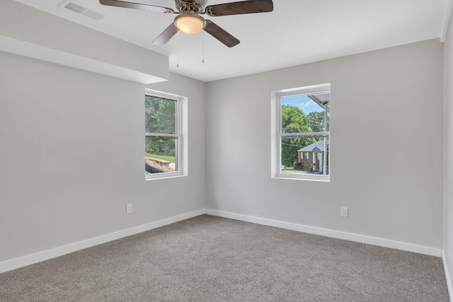 spare room featuring ceiling fan and carpet flooring