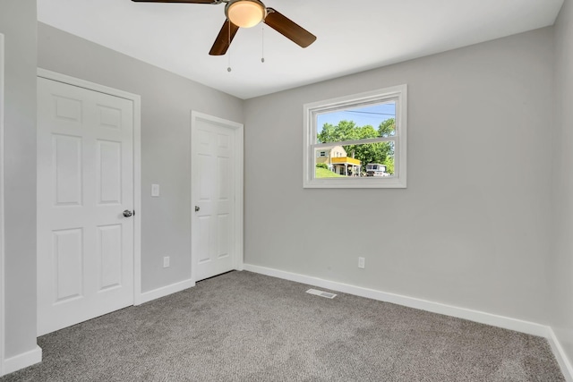 unfurnished bedroom with ceiling fan and carpet floors