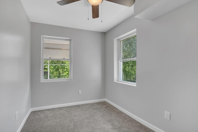 carpeted empty room featuring ceiling fan and plenty of natural light