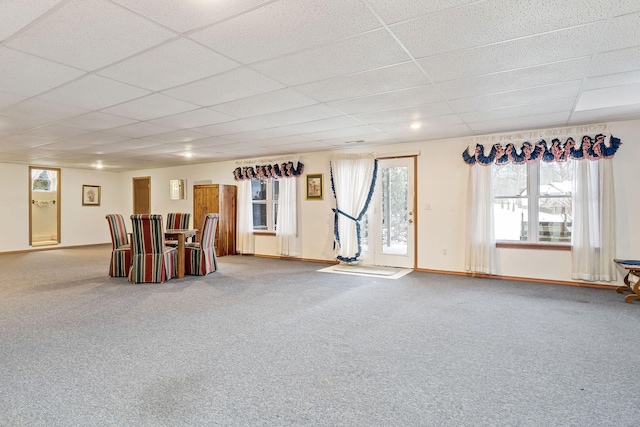 interior space featuring carpet floors and a drop ceiling