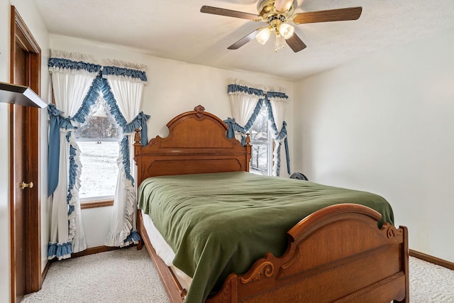 bedroom with ceiling fan and light carpet