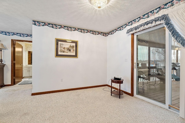 carpeted spare room featuring a textured ceiling