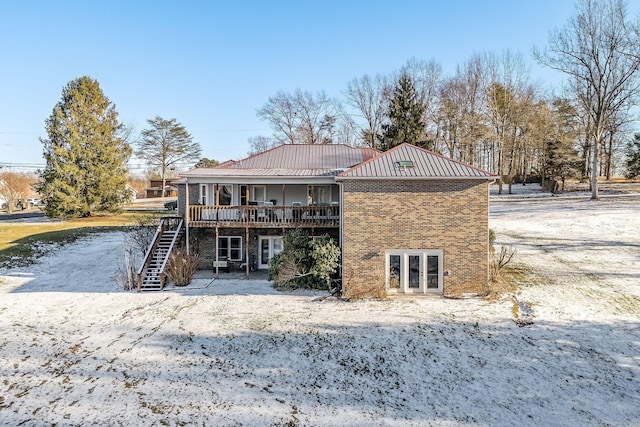 rear view of house featuring a wooden deck